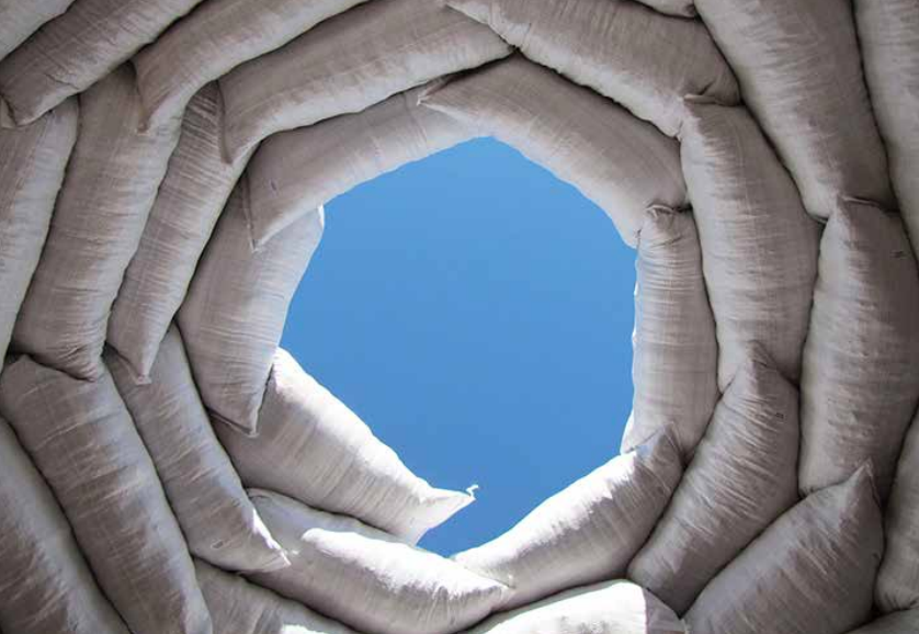 2.1: Looking straight up inside an earthbag dome shows the spiraling pattern of bags closing in to cap the dome. This was a small, mostly underground dome with earthen fill situated in the desert southwestern United States. Credit: Kelly Hart